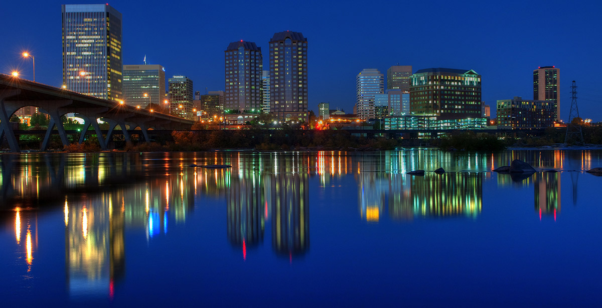 A view of the Richmond skyline across the James River at night.