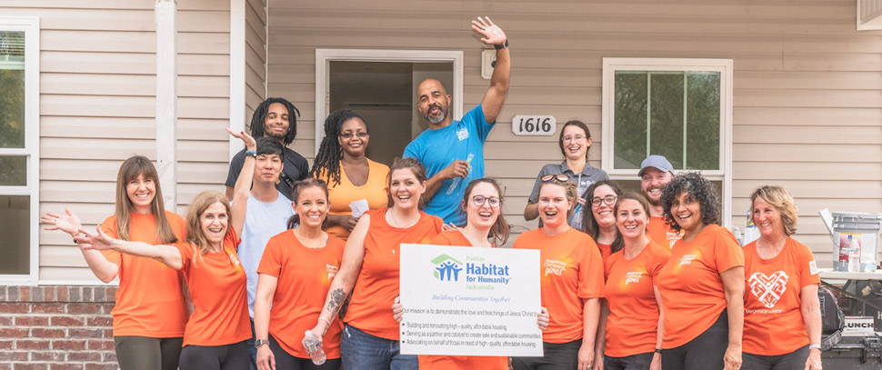 Regency employees pose in front of home they helped build for HabiJax.